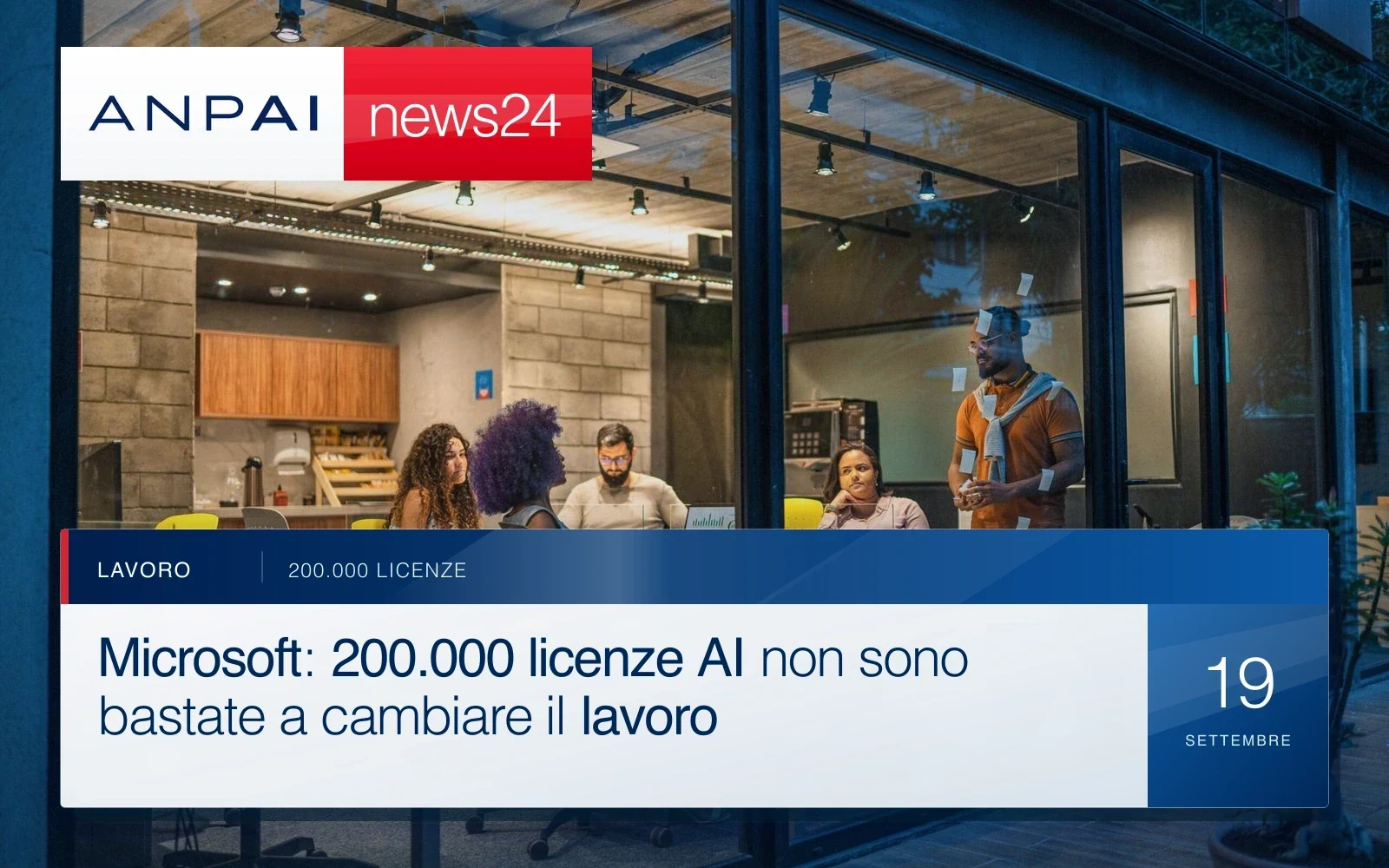 Team al lavoro in una sala riunioni con vetrate e strumenti digitali