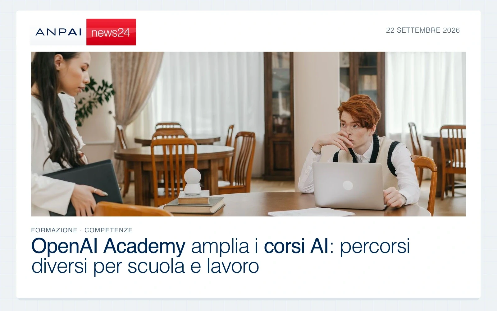 Due studenti studiano con libri e computer portatili a un tavolo in biblioteca.